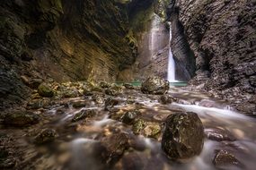 waterfall falls on stones