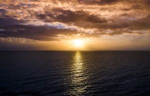 the rays of the morning sun are reflected in the ocean