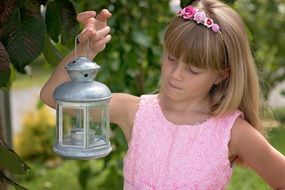 young girl in pink dress in the garden