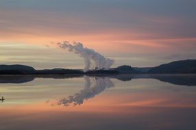 sunset landscape with Mountains, mirroring on calm lake