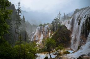 panorama of a waterfall in a dense forest