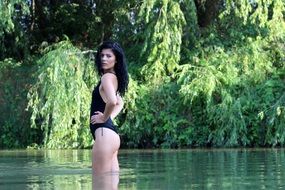 girl with long black hair in the water