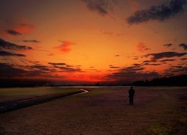 man on the lake at sunset