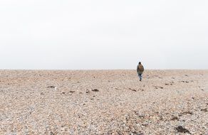 man on the stone beach