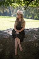girl in a black dress under a tree