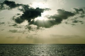 ocean in the sun's rays through the cloud with reflections on the water