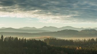 scenic panorama view of forested Mountains at sunrise