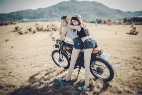 girls posing on a motorcycle