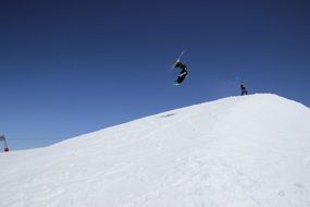 freestyle skiing, jumping man above snowy hill at Blue Sky