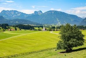 panorama of a green meadow at the foot of the alps in bavaria