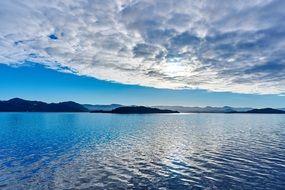 cumulus clouds over water