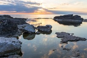 rocky ocean beach at the sunset
