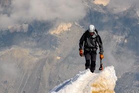 climber on top of a snowy mountainer