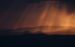 the orange rays of the sun penetrate the black clouds in South Africa