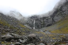 Waterfall in Mountains on Foggy weather