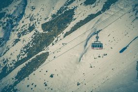 panorama of a cable car above the snowy alps