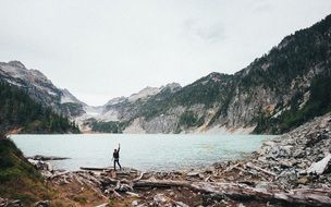 landscape of man is delighted with the mountain lake