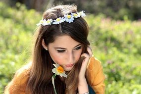 young woman with flower wreath outside