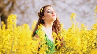 young beautiful Girl among Yellow Flowers