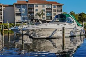 white yacht parked on water near the pier