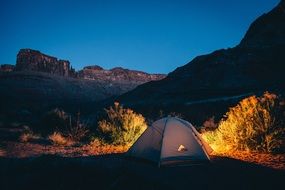 landscape of Tent in rocky wilderness at dusk