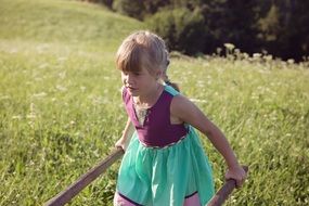 Child girl on a meadow
