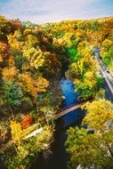 Bridge across River and road through Forest at autumn, top view