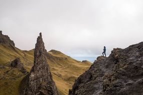 silhouette of a girl on a cliff