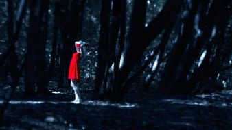 Girl with banded eyes in Red Dress In dark Forest