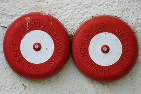 Red and white fire detectors on the wall