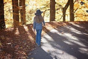 girl with long hair walking in the colorful autumn park