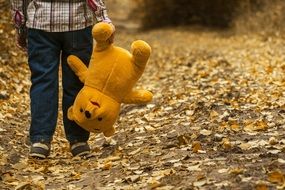 Child with Bear toy, Autumn scene