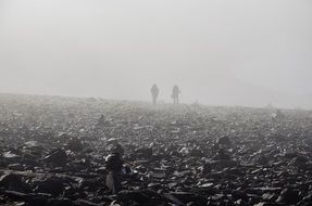 tourists on a foggy mountain