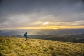 hiker on top of the mountain at sunset background