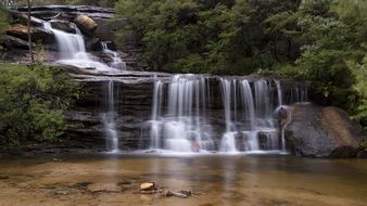 beautiful Waterfall in Mountain Forest at summer