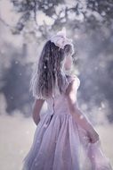 girl in carnival dress in the garden in a blurred background