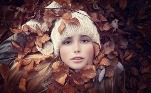 beautiful girl among the golden autumn foliage