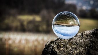 glass ball on a boulder