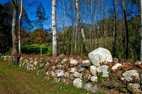 Colorful stone Wall Fence among the colorful plants on the beautiful landscape in Connecticut