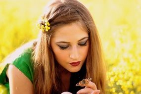 butterfly sitting on the female hand