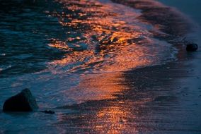 reflection of the orange sun in the water on the ocean