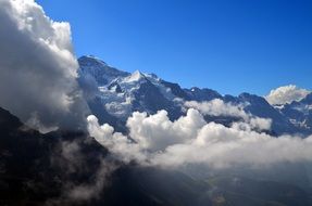 distant view of a glacier in the clouds in switzerland