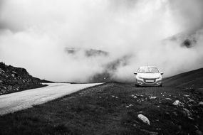 Peugeot white car stands on the mountain