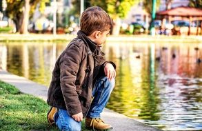 boy by the lake in the park