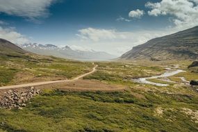 road in a green valley