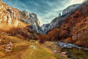 river between mountains in autumn