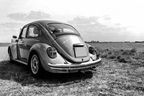 black and white photo of an old car on the road