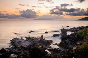 coast near the ocean with stones at dusk
