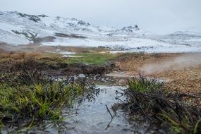 brook in valley at snowy mountains