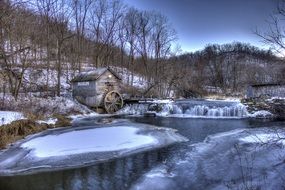 old mill by the river in winter